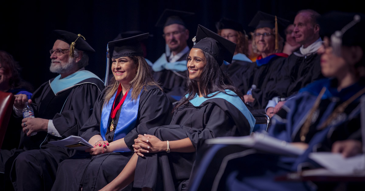 faculty and students at graduation ceremony